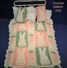 a crocheted bed with pillows and blankets on it