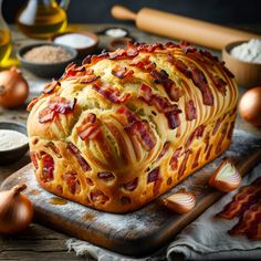 a loaf of bacon bread sitting on top of a cutting board next to other ingredients