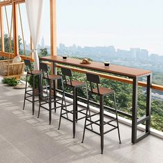 there are four bar stools at the top of this balcony with an amazing view