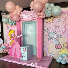 there is a pink and blue birthday party with balloons on the wall, princesses at the door