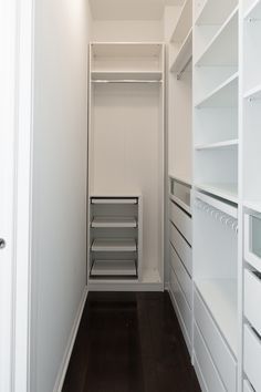 an empty walk in closet with shelves and drawers