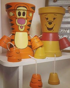 some toys are sitting on a shelf in a room that is decorated like winnie the pooh and tigger