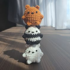 three crocheted toys are stacked on top of each other in the shape of animals