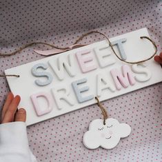 a sign that says sweet dreams hanging from a string