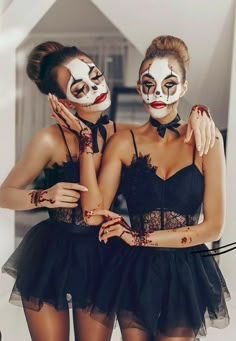 two women with painted faces are posing for the camera in tutu skirts and masks