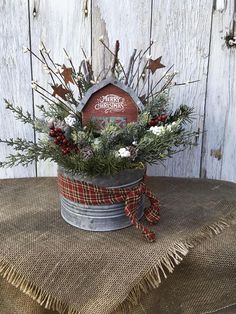 an old tin can with christmas decorations in it on top of a burlock