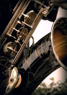 a close up view of a saxophone with its mouth open and the instrument in focus