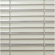 a white tile wall with horizontal lines on the bottom and one line at the top