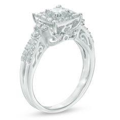 a white gold engagement ring with an oval shaped center stone surrounded by smaller round diamonds