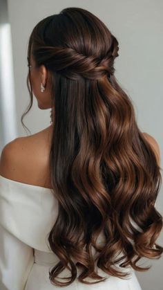 a woman with long brown hair wearing a half up hairstyle and an off the shoulder dress