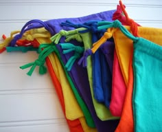 a pile of colorful towels hanging on a wall next to a garage door with white doors in the background