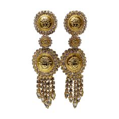 Snag yourself these hoops! Circa late 1980s/early 1990s, these gold plated Versace dangle earrings are embossed with the signature Medusa head and are embellished with rhinestones and fringe. Clip on closures. Pair with your favorite Versace silk shirt and black leather leggings! 4" long. Versace Accessories Jewelry, Greece Moodboard, Versace Silk Shirt, Versace Earrings, Black Leather Leggings, Versace Gold, Versace Jewelry, Gold Outfit, Medusa Head