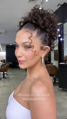 Unleash your beauty with our collection of curly hairstyles! Find your next head-turning look, from bouncy ringlets to soft, romantic waves. Elegant Curly Bun Hairstyles, Elegant Updo For Naturally Curly Hair, Curly Hair Updo Homecoming, Hoco Hairstyles Updo Curly Hair, Formal Hairstyle Curly Hair, Curled Updo Hairstyles Prom, Short Curly Hair Hoco Hairstyles, Bride With Naturally Curly Hair, Prom Curly Updo