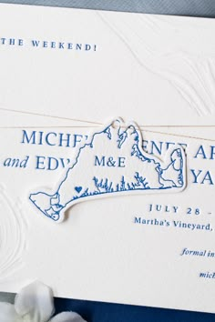 a blue and white wedding card with the map of michigan on it