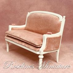 a dollhouse miniature couch and chair on a pink background with the caption's name written below it