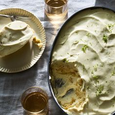 a pan filled with mashed potatoes next to two glasses