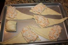 four uncooked ravioli on a baking sheet