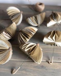 an arrangement of folded books on a wooden table