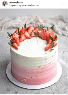 a cake with white frosting and strawberries on top