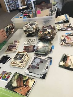 a table covered with lots of pictures and papers