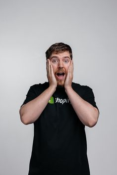 MrBeast looks surprised, pressing his hands to his cheeks, while wearing a black t-shirt with the Shopify logo Free Money Online, Dropshipping Website, Earn Money Online Free, Earn Free Money, Hustle Money, Email Marketing Software, Shopify Website Design