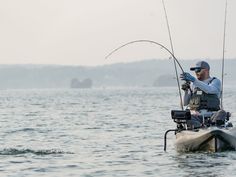 a man on a boat fishing in the water