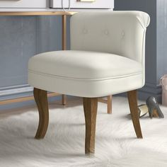 a white chair sitting on top of a carpet covered floor