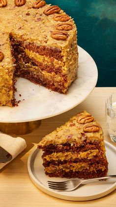 a piece of cake on a plate with a fork next to it and another slice missing