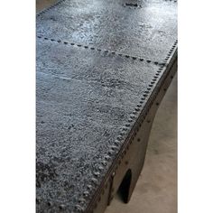 a metal table with rivets and holes on the top is shown in this image