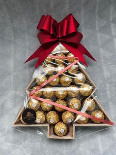 a christmas tree made out of chocolates and wrapped in red ribbon