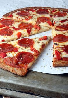 a pepperoni pizza is cut into slices on a tray with one slice missing from it