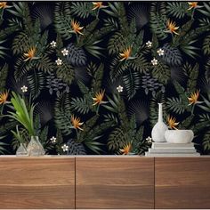 an image of a wallpaper with tropical leaves and flowers on the sideboard next to a dresser