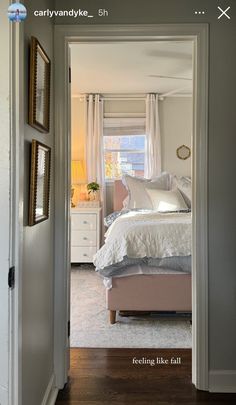 an open door leading to a bedroom with a bed and dresser in the corner,