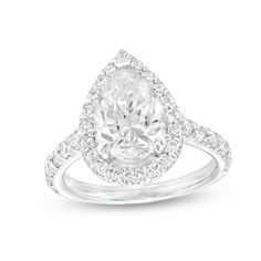 a pear shaped diamond engagement ring set in 18k white gold with diamonds around the band