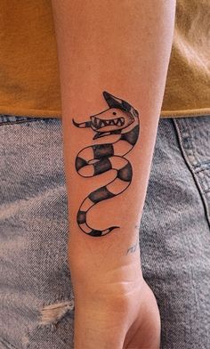 a person with a snake tattoo on their arm