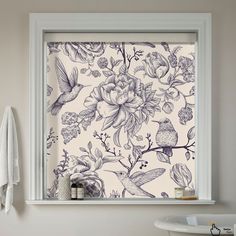 a bathroom window with flowers and birds on it