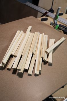 several pieces of wood sitting on top of a table next to a pair of scissors