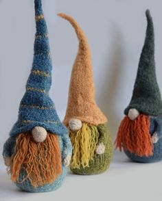 three knitted gnomes with different colors and sizes