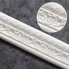 white decorative molding on the side of a gray carpeted area with a circular hole in the center