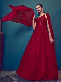 Are you looking for a gown that will elevate your look for a wedding, reception, party, sangeet, or to stand out as a beautiful bridesmaid? Look no further than the Mesmerizing Red Sequins Georgette Ready-Made Bridesmaid Gown, available now from Ethnic Plus. With its stunning red color and intricate sequin work on delicate georgette fabric, this gown is sure to catch the eye of everyone in the room. The attached dupatta adds an extra touch of elegance and sophistication to this already show-stop Elegant Georgette Wedding Gown, Festive Party Lehenga With Fitted Bodice, Elegant Georgette Gown For Prom, Elegant Georgette Prom Gown, Festive Georgette Evening Dress For Party, Elegant Festive Georgette Evening Dress, Glamorous Gown With Sheer Dupatta For Festive Occasions, Glamorous Festive Gown With Sheer Dupatta, Red Evening Dress For Wedding Party Season