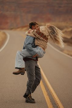 a man carrying a woman on his back down the road