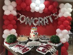 the dessert table is decorated with red and white balloons