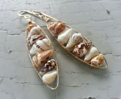 two pairs of earrings with shells on them