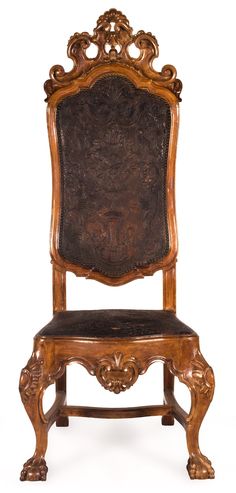 an antique wooden chair with leather seat padding and carved wood frame, isolated against a white background