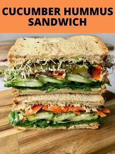 a close up of a sandwich on a cutting board with the words cucumber hummus sandwich