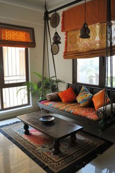 a living room filled with lots of furniture and hanging decorations on the wall next to a window