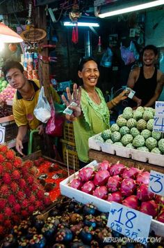 some people are standing at an open air market