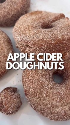 there are three donuts with sugar on them and the words apple cider doughnuts