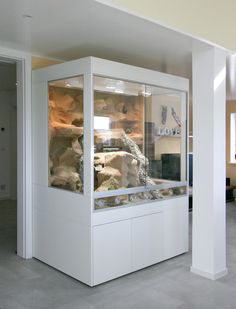 a large display case with rocks in it's center and on the other side