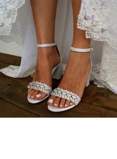 the bride's feet are wearing white shoes